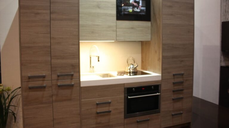 Think This Is Just a Wall of Cabinets? Look What This Small Kitchen Fits Behind the Doors