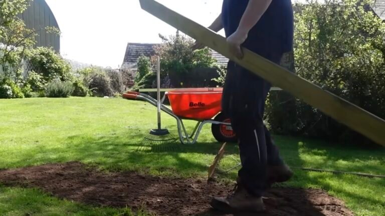 Use An Old Wood Plank And Rake To Smooth And Level Your Yard