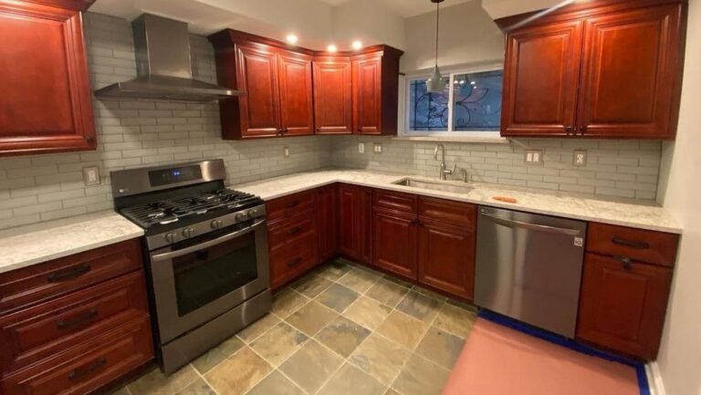 He Spray Painted the Dark Wood Cabinets White and Navy and the Kitchen Took on a Custom-Built Look